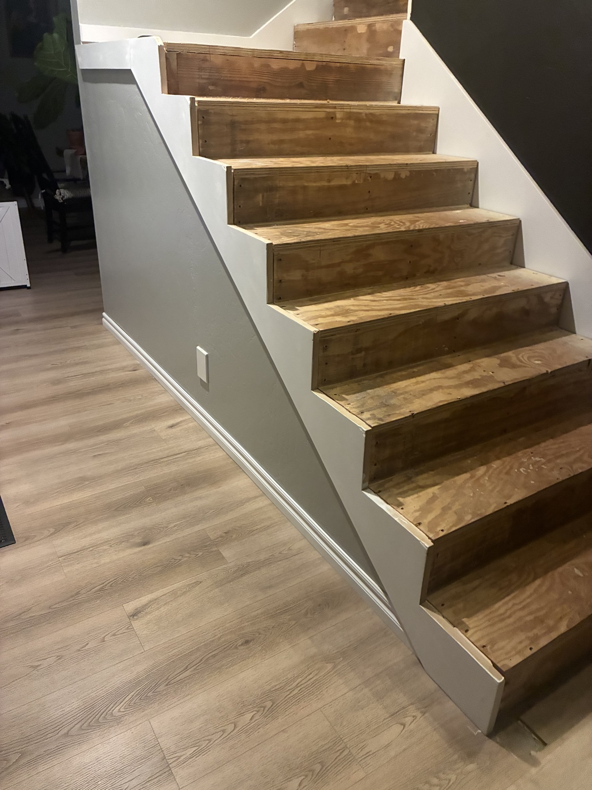 Finished staircase with painted walls and white trim